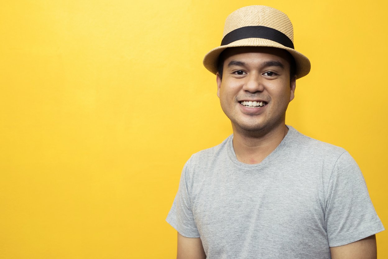 Handsome men in a good mood, bright yellow background room