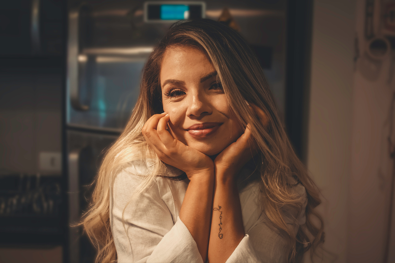 A Blonde-Haired Woman in White Top Smiling