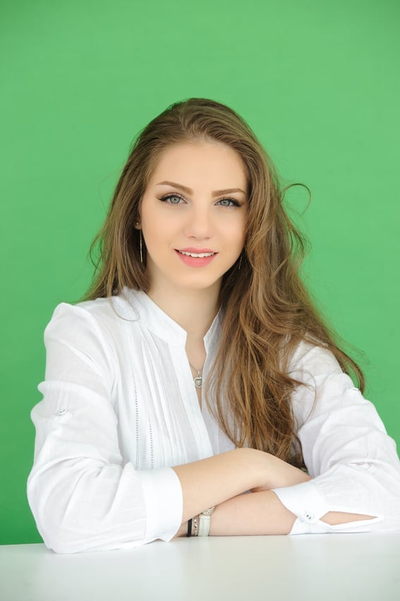 portrait of beautiful young woman over green screen background